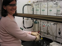 Heather Lucas, a post-doctoral fellow, is using the Schlenk line in fume hood